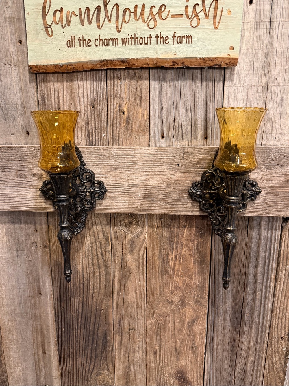 Pair of vintage gothic metal wall sconces ornate wall plates and amber glass